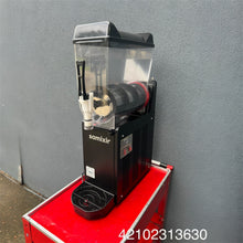 Load image into Gallery viewer, Black and red slush machine with Samixir branding against a gray wall.